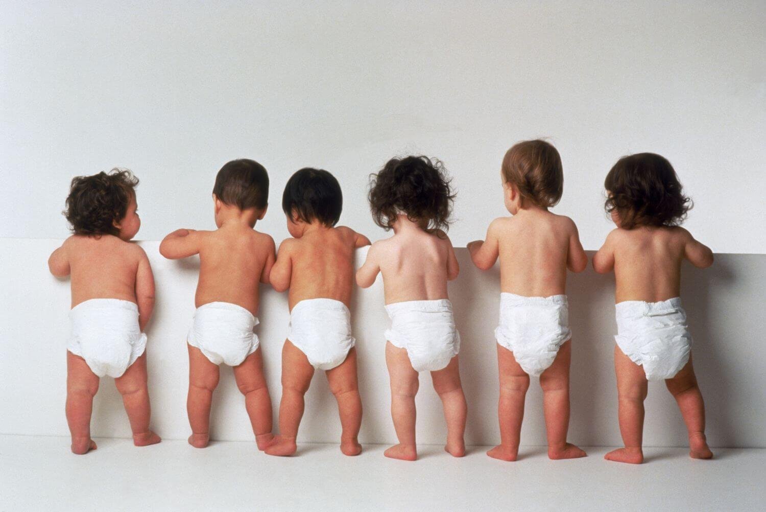 Canadian parent holding expensive box of diapers showing high costs of baby care