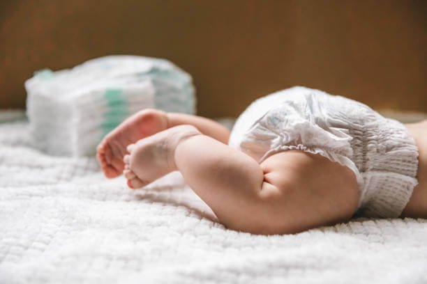 Parent using smartphone to find free diaper samples through online communities and apps