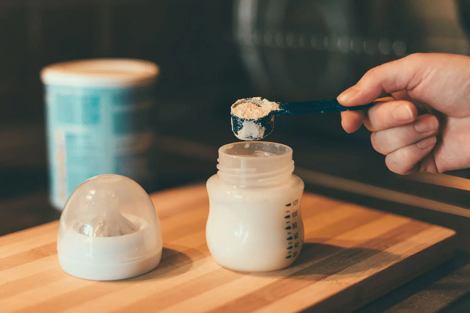 Parent feeding baby with formula bottle showing safe feeding practices for Canadian infants