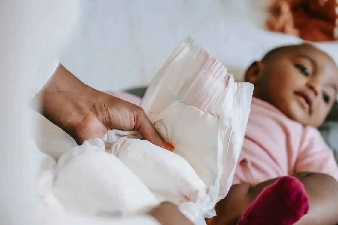Happy Canadian baby in diaper with parents researching free sample programs