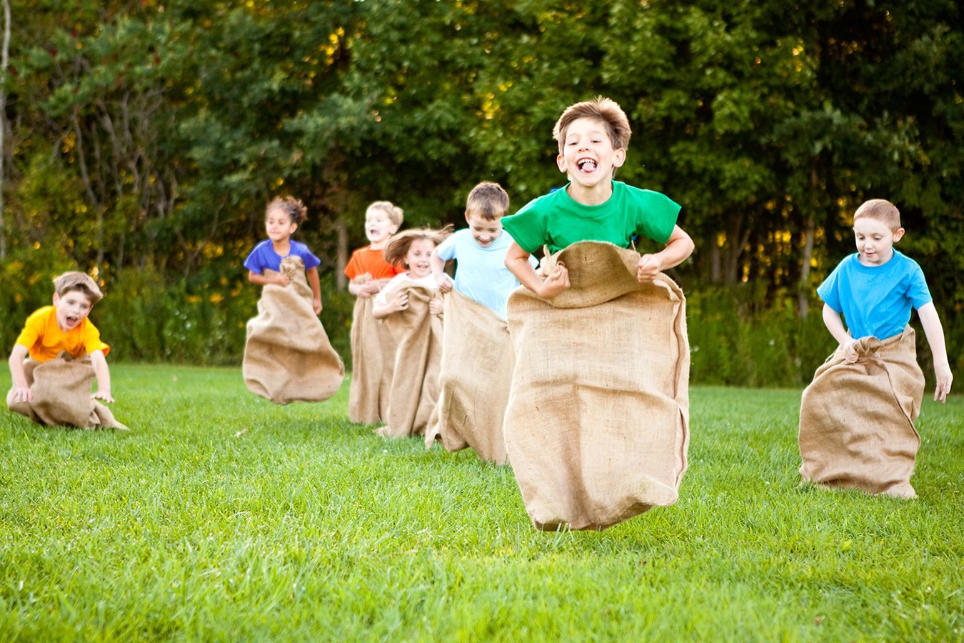 Kids enjoying outdoor party games and sports activities during summer fun