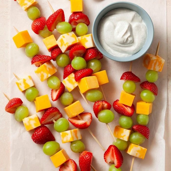 Colorful fruit and cheese kabobs arranged for kids lunch snacks
