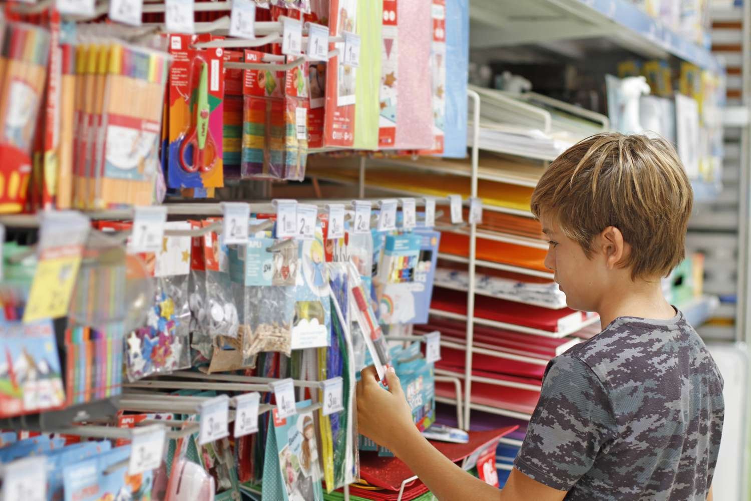 Parent and child shopping together for back to school supplies and clothing