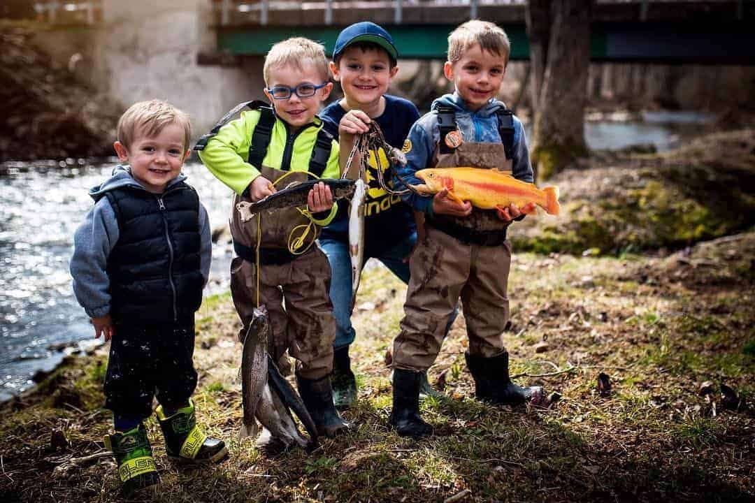 Fall outdoor activities for kids in Canada showing children playing in autumn leaves