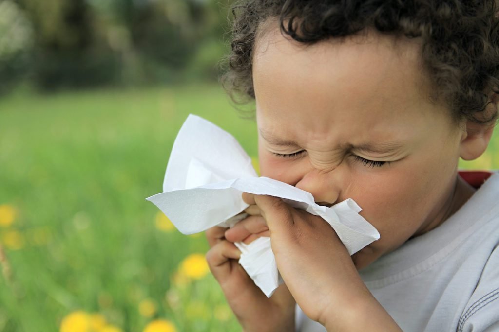 Healthcare professional examining Canadian toddler for seasonal allergy symptoms and management strategies
