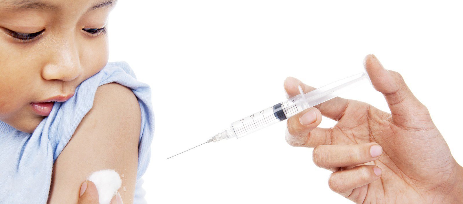 Canadian baby receiving flu shot vaccination at pediatric health clinic