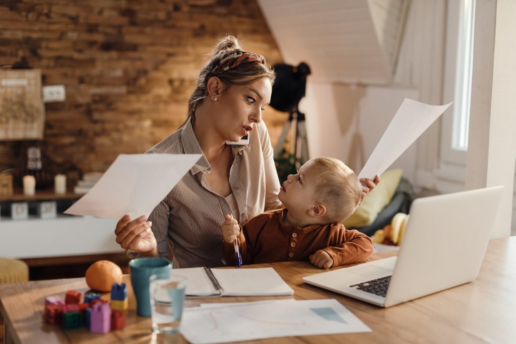 Canadian single mother managing family budget while working from home with child