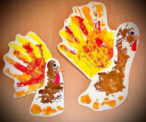 Canadian baby's first Thanksgiving footprint craft with autumn leaves and holiday keepsakes