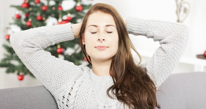 Person practicing mindful relaxation to relieve holiday stress