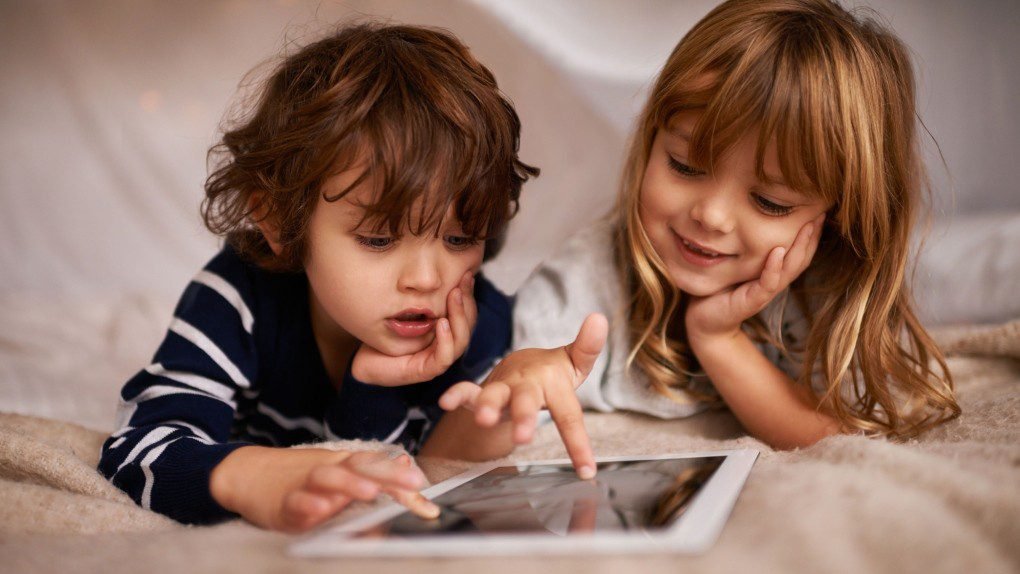 Parent and child reviewing a family media plan together