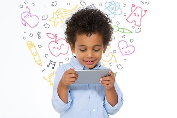 Child using screen device — research links excessive screen time to overstimulation in young children